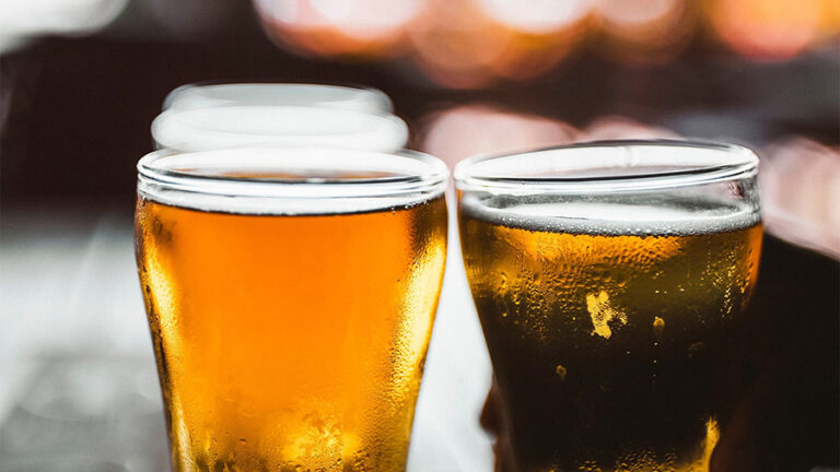 Close up of glasses of golden beer.