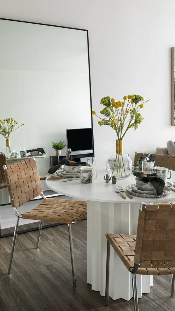 Apartment dining room with wood-style flooring.