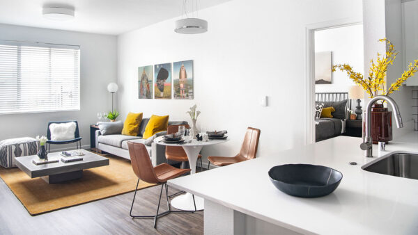Apartment dining and living room with wood-style flooring.