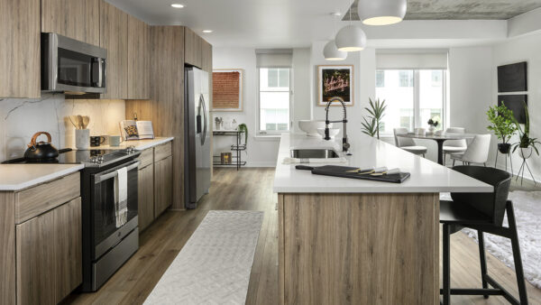 Apartment Kitchen with Stainless Steel Appliances, Dining Room and with wood floors.