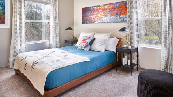 Spacious apartment bedroom with carpeted floors.