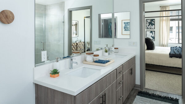 Apartment Bathroom with Double Sink and hardwood flooring.