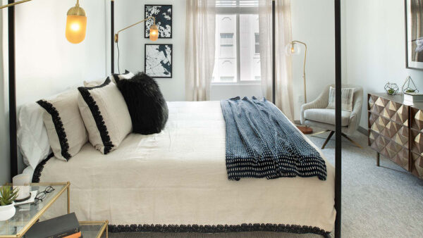 Spacious apartment bedroom with carpeted floors.