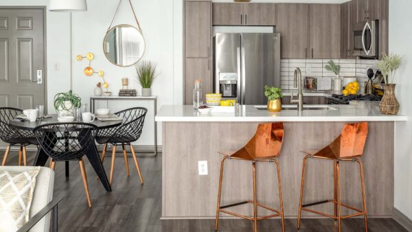 Apartment Kitchen with Stainless Steel Appliances, quartz counters and wood floors.