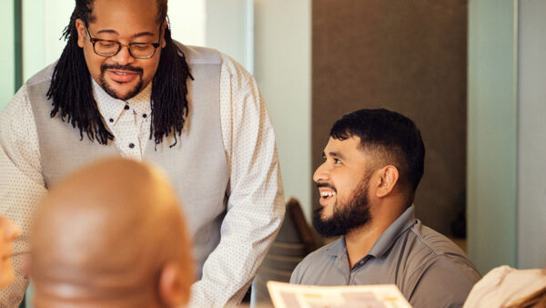 Griffis employees laughing together during meeting.