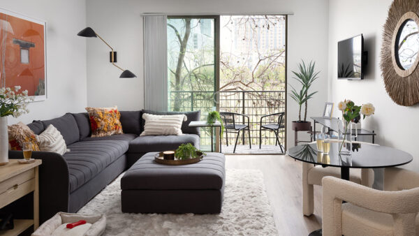 Apartment living room with wood-style flooring with balcony or patio.