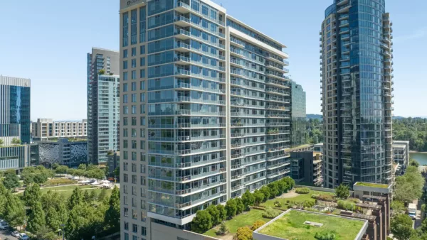 Griffis at Seattle Waterfront apartments with grassy rooftop deck and modern glass construction.
