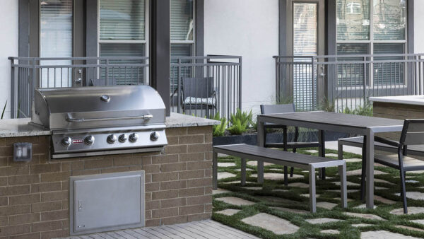 Outdoor grilling station with built in BBQ grills and dining tables.