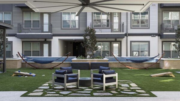 Outdoor lounge with hammocks, water features, and outdoor seating.