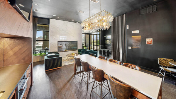 Resident lounge with plush seating, wood style floor, and fireplace.