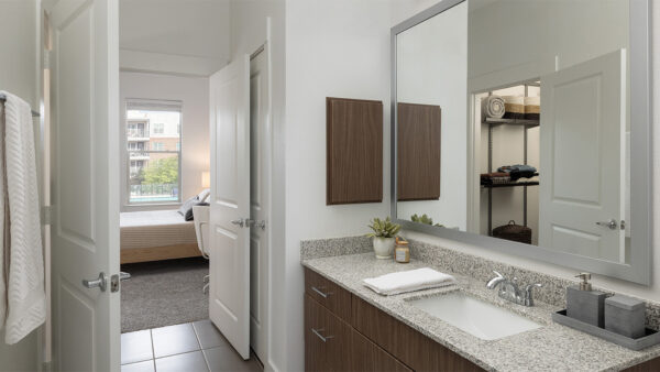 Apartment Bathroom with spacious closet and tile flooring.