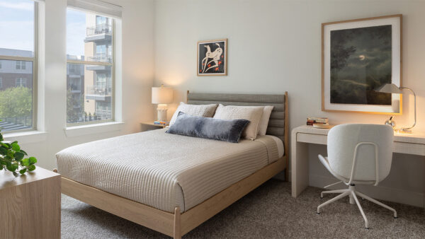 Spacious apartment Bedroom with plush carpet flooring.