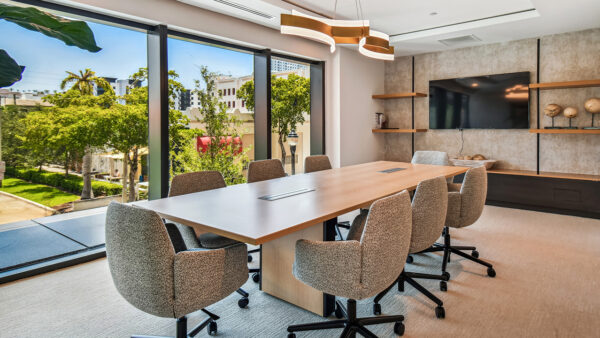Griffis West Palm apartments coworking lounge conference room with large conference table.