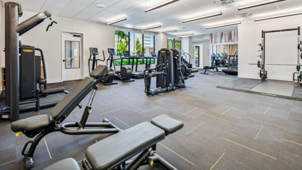 Griffis West Palm apartments fitness center with cardio machines and weight equipment.