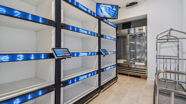 Griffis West Palm apartments package room with parcel delivery shelves.