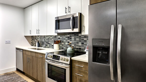 Apartment Kitchen with Stainless Steel Appliances and Quartz Countertops