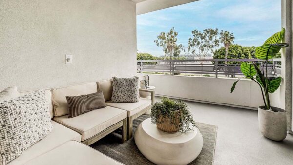 Griffis Platinum Triangle apartment balcony with lounge chairs.