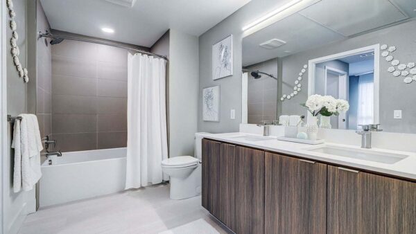 Griffis Platinum Triangle apartment bedroom with wood style floor.