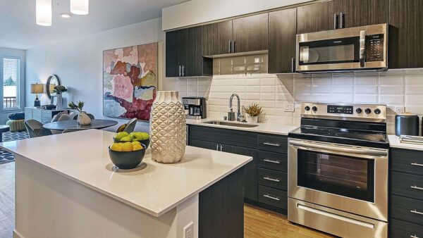 Griffis Shoreline apartment kitchen with quartz countertops and stainless steel appliances.