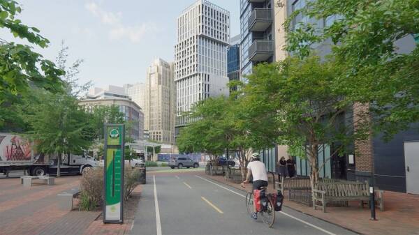 Cyclist on a tree-lined bike trail in downtown Bethesda, Maryland.