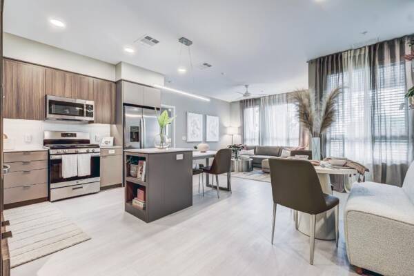 Griffis Platinum Triangle two-bedroom apartment kitchen with an island and dining area.
