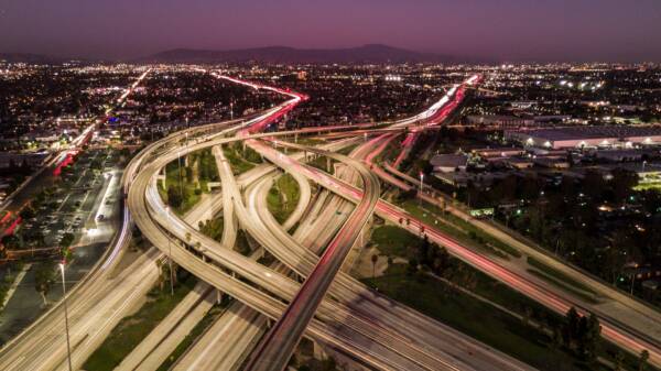 Freeway interchange with light trails at night in Orange County, California.