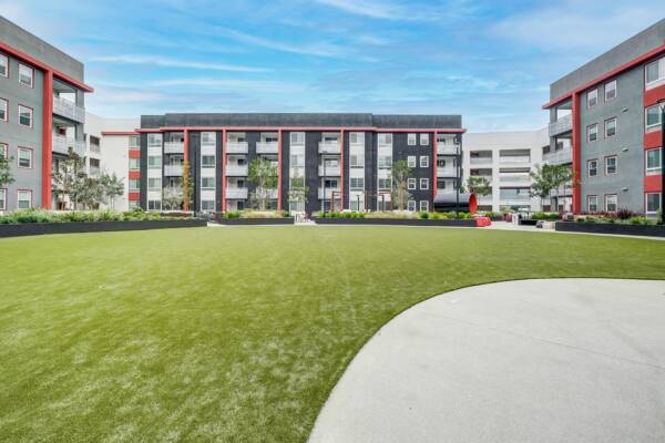Griffis Platinum Triangle courtyard lawn surrounded by modern apartment buildings.