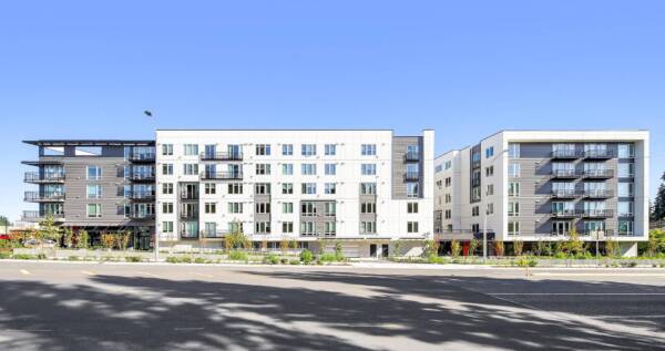 Griffis Shoreline modern apartment building exterior under a clear blue sky.