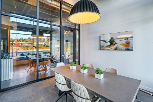 Griffis Shoreline conference room with a long table, pendant light, and floor-to-ceiling windows.