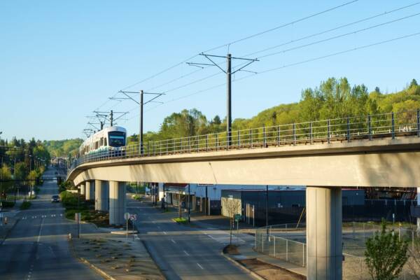 Link light rail train crossing an elevated bridge in the Seattle area.