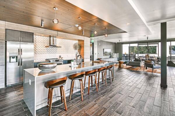 Griffis Shoreline resident lounge with a community kitchen island and bar seating.