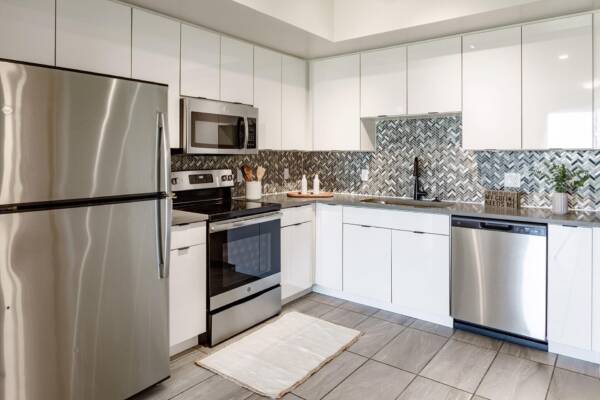 Griffis Pompano Beach Apartment Kitchen with Stainless Steel Appliances and Quartz Countertops