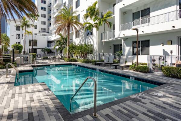 Pool with lounge chairs at Griffis Pompano Beach.
