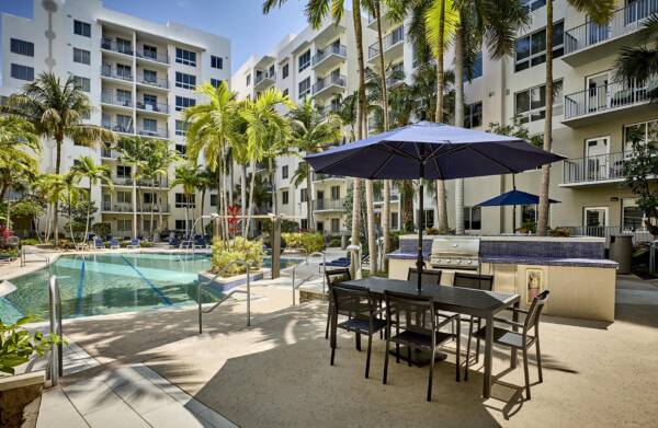 Pool deck with BBQ grills at Griffis North Olive.