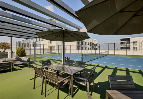 Rooftop tennis court with courtside tables at Griffis North Olive.