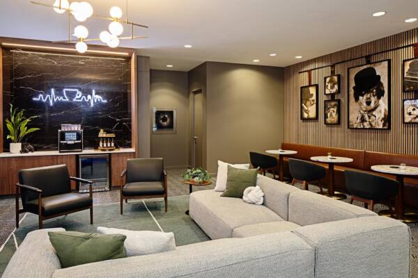 Griffis Seattle Waterfront resident café lounge with sofas, bar seating, and a neon sign