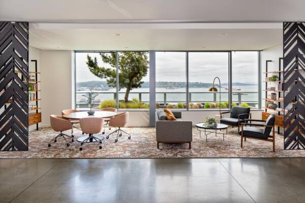 Griffis Seattle Waterfront coworking lounge with work tables and waterfront views