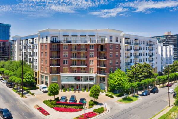 Aerial view of the Griffis Uptown brick apartment building on a tree-lined street in Uptown Dallas