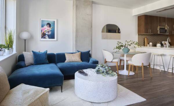 Griffis Platform Union Station apartment living room with blue sectional sofa and open dining area