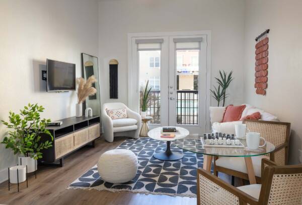Griffis at The Domain apartment living room with wood style floor and balcony door.