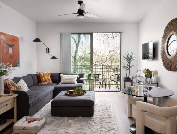 Griffis at The Domain apartment living room with wood style floor and balcony door.