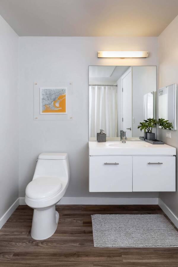 Griffis East Village apartment bathroom with wood style floor in San Diego, CA.