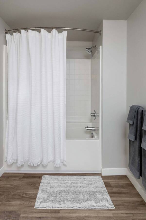 Griffis East Village apartment bathroom with wood style floor and soaking tub in San Diego, CA.