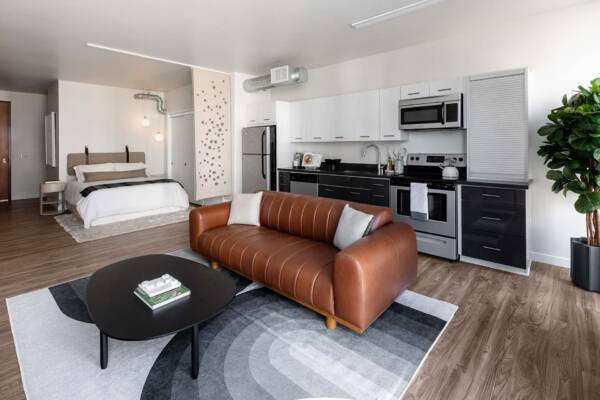Griffis East Village apartment living area with wood style floor in San Diego, CA.