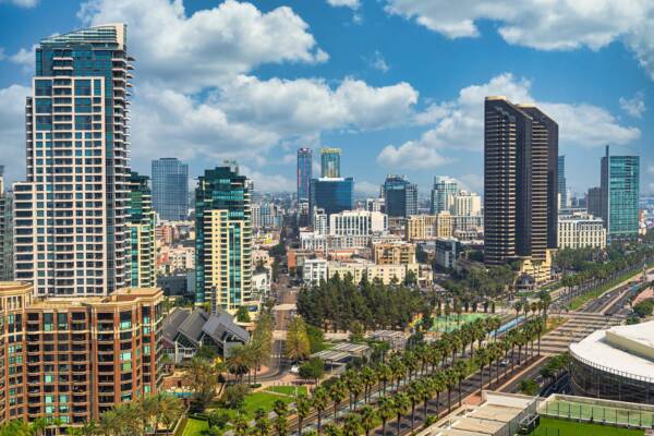 San Diego skyline under cloudy blue skies.