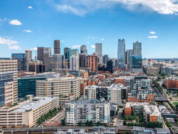 Denver skyline under cloudy blue skies near Griffis LoDo.