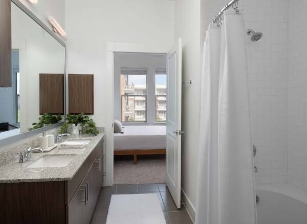 Griffis Oak Lawn apartment bathroom with tile floor and soaking tub.