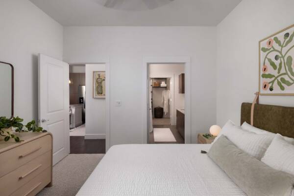 Griffis Oak Lawn apartment bedroom with carpet floor and bathroom door.