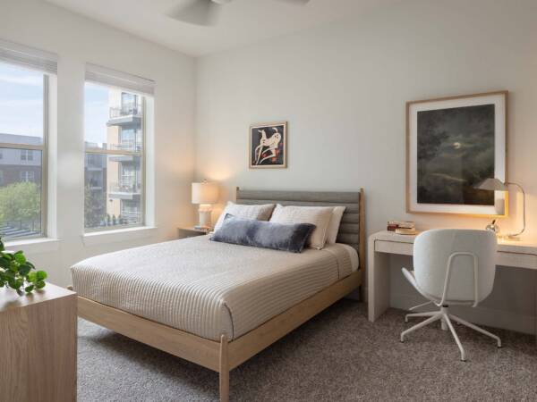 Griffis Oak Lawn apartment bedroom with carpet and desk.