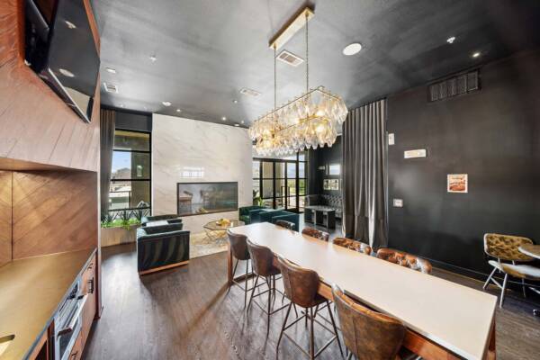 Griffis Oak Lawn community resident lounge with dining table in Dallas, TX.